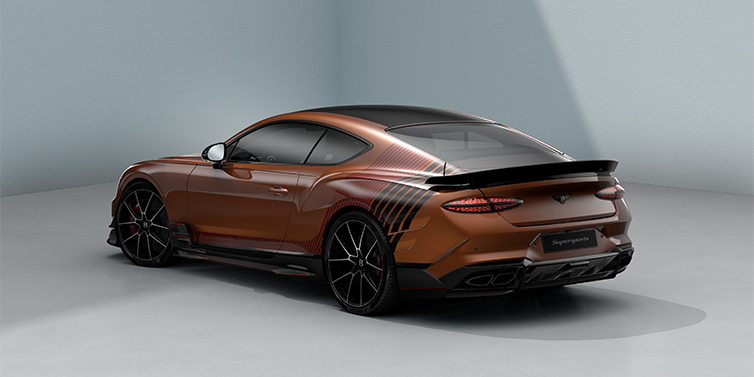 Bentley Hannover Bentley Supersports rear three quarter in "Meteorite" Design theme with Orange Flame paint and Beluga Black and Candy Red paint stripes across the rear haunch.